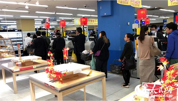 12日晚，日本千葉縣某超市內，當地民眾為應對19號大型台風登陸正在大量採購物資。貨架上大部分商品被一掃而空。