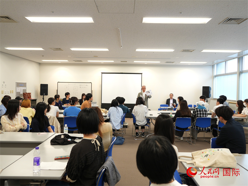 活動報告會現場。人民網 許可攝